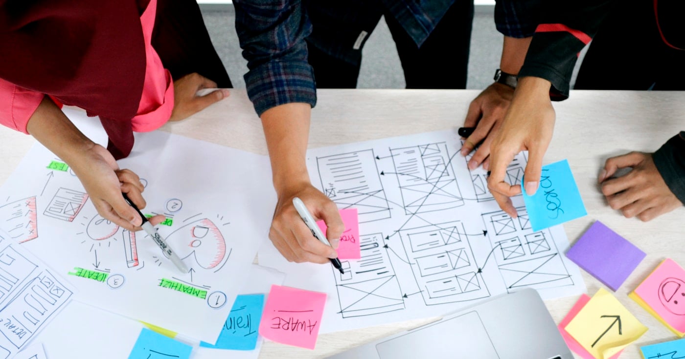 Creative thinking brainstorming session with sticky notes and design tools